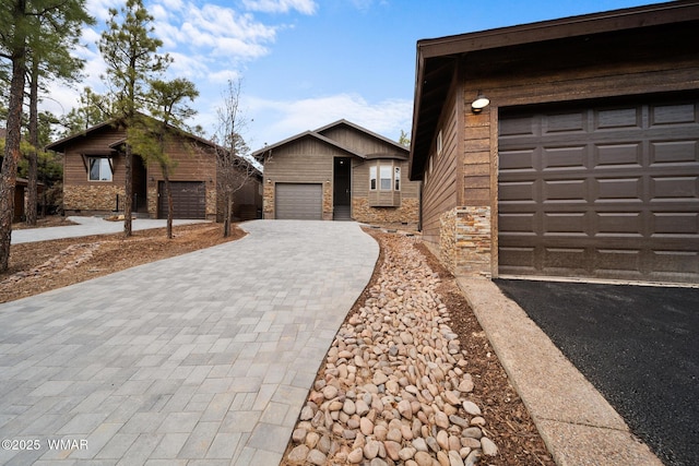 view of front of home featuring a garage and decorative driveway