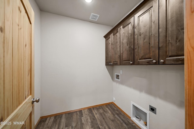 clothes washing area featuring hookup for an electric dryer, visible vents, baseboards, cabinet space, and dark wood-style floors