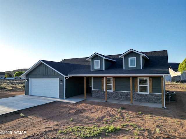 1316 W 7th St S, Snowflake, AZ 85937 - view of front of home with a garage, concrete driveway, covered porch, board and batten siding, and a shingled roof