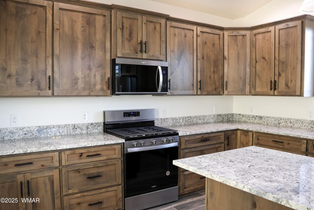 1316 W 7th St S, Snowflake, AZ 85937 - kitchen featuring appliances with stainless steel finishes, light stone countertops, and dark wood-type flooring