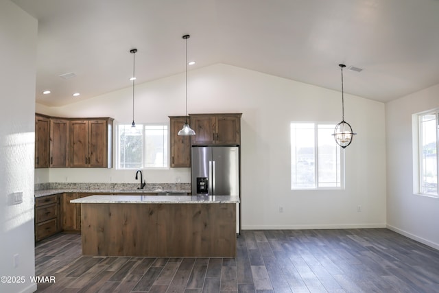 1316 W 7th St S, Snowflake, AZ 85937 - kitchen with a kitchen island, stainless steel fridge, dark wood-type flooring, light stone counters, and hanging light fixtures