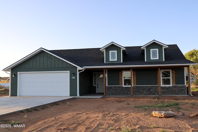 1316 W 7th St S, Snowflake, AZ 85937 - view of front of house with concrete driveway, a garage, a porch, and stone siding