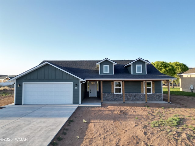 1316 W 7th St S, Snowflake, AZ 85937 - view of front facade featuring an attached garage, driveway, stone siding, a shingled roof, and a porch