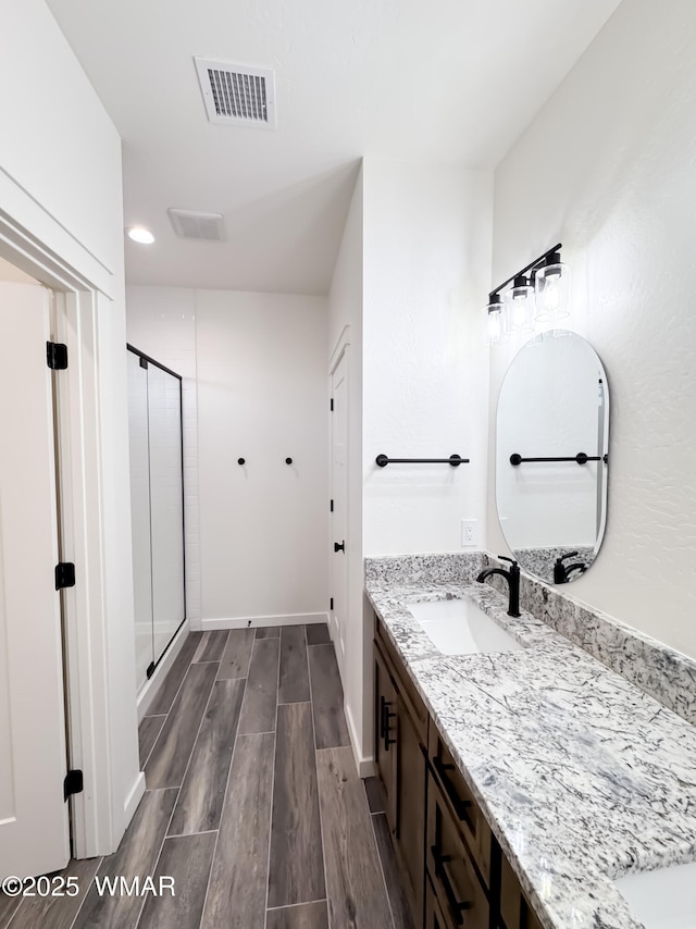 1316 W 7th St S, Snowflake, AZ 85937 - bathroom with wood finish floors, a shower stall, vanity, baseboards, and recessed lighting
