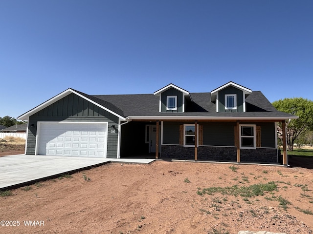 1316 W 7th St S, Snowflake, AZ 85937 - view of front facade with concrete driveway, a garage, covered porch, and stone siding