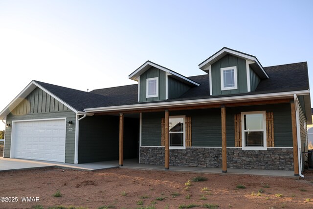 1316 W 7th St S, Snowflake, AZ 85937 - craftsman-style home featuring a porch, an attached garage, driveway, board and batten siding, and stone siding