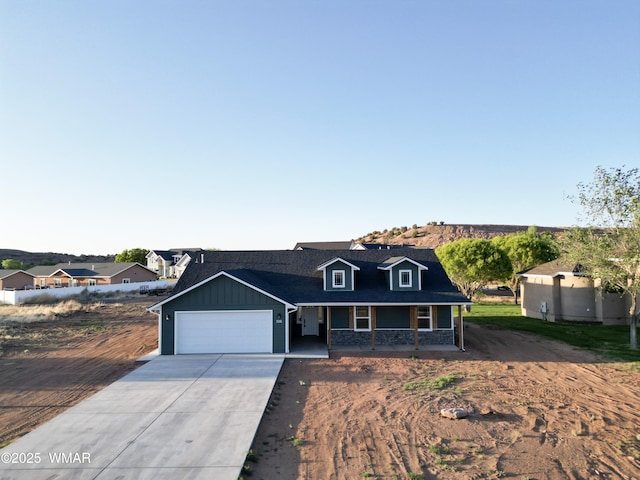 1316 W 7th St S, Snowflake, AZ 85937 - view of front of home featuring a porch, concrete driveway, an attached garage, and board and batten siding