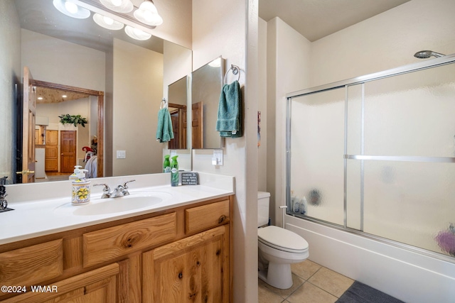 2740 W Maple Ln, Show Low, AZ 85901 - full bathroom with toilet, tile patterned floors, bath / shower combo with glass door, and vanity