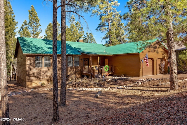2740 W Maple Ln, Show Low, AZ 85901 - rustic home featuring covered porch, a chimney, an attached garage, and metal roof