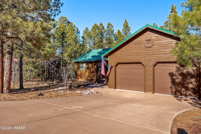 2740 W Maple Ln, Show Low, AZ 85901 - rustic home with a garage and concrete driveway