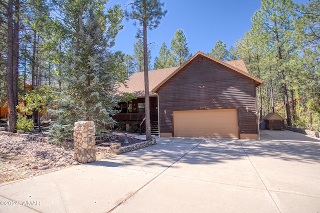 view of front of property with a garage, concrete driveway, and roof with shingles