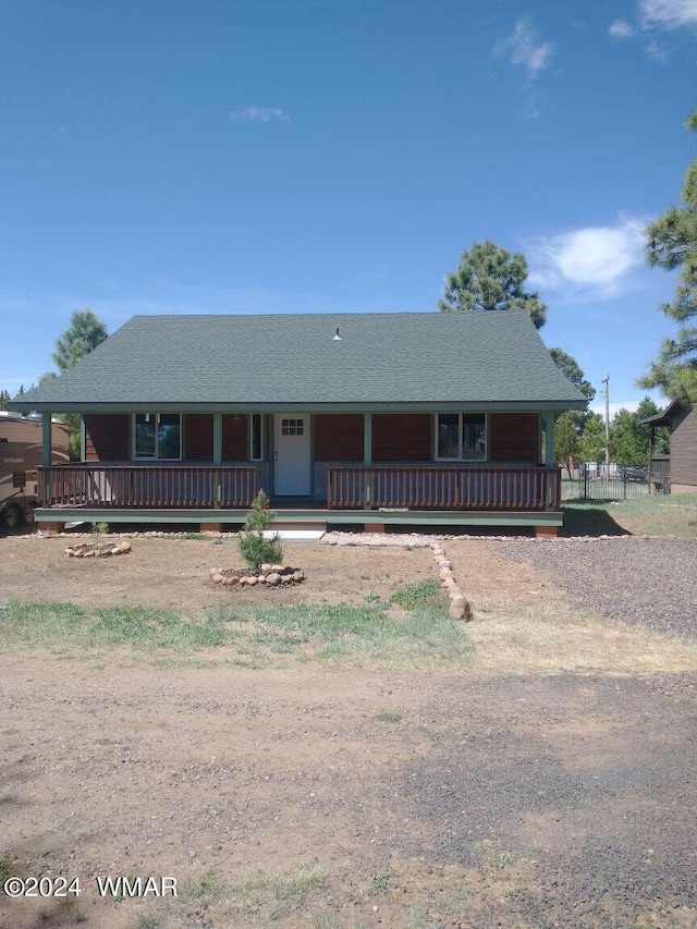 view of front of property with a porch and a shingled roof