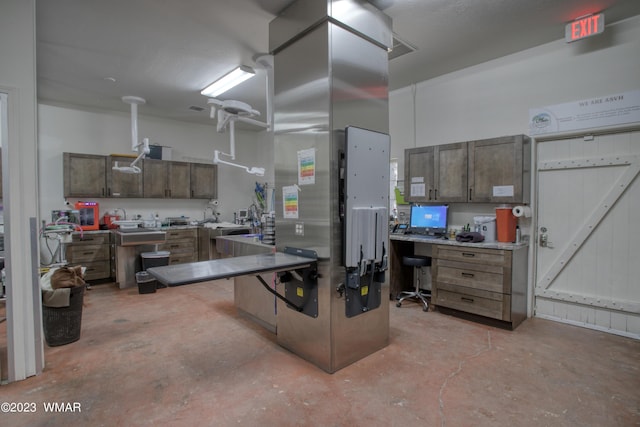 kitchen featuring unfinished concrete floors and light countertops