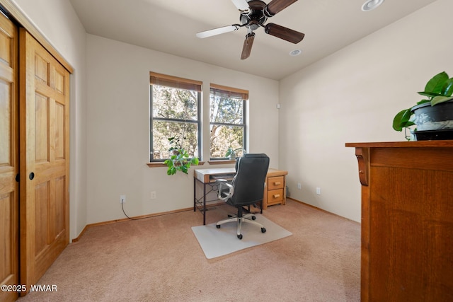 office area featuring light carpet and ceiling fan