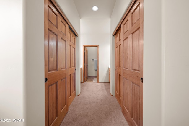 hall with light colored carpet