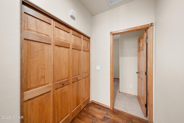 hall with dark wood finished floors and baseboards