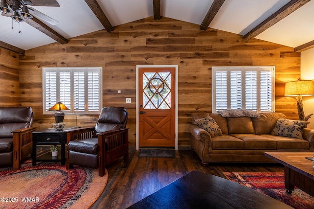 living area featuring dark wood-type flooring, lofted ceiling, and a healthy amount of sunlight