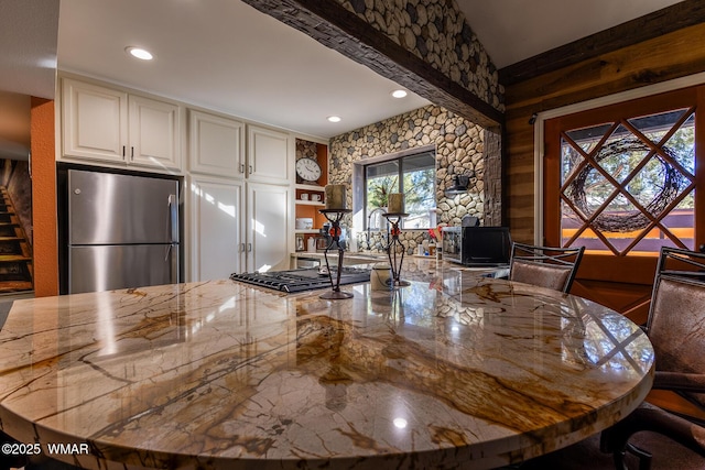 kitchen with stainless steel appliances, light stone counters, and recessed lighting