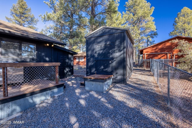 view of shed featuring fence