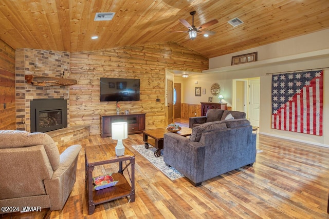 living area with lofted ceiling, visible vents, wood finished floors, and wood ceiling