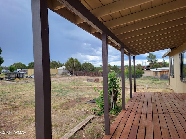 wooden terrace featuring fence