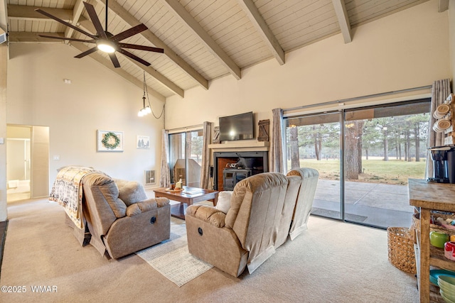 living room featuring carpet floors, beam ceiling, high vaulted ceiling, and a wealth of natural light