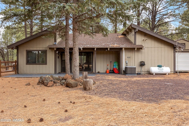 view of front of property with central AC and a shingled roof