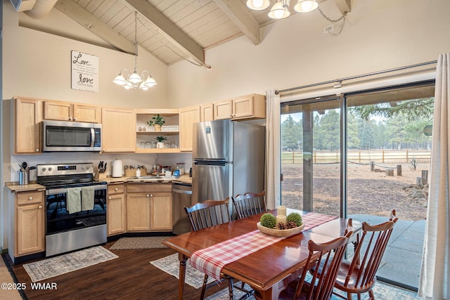 kitchen featuring an inviting chandelier, high vaulted ceiling, stainless steel appliances, and light brown cabinetry