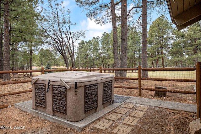 view of patio featuring fence and a hot tub