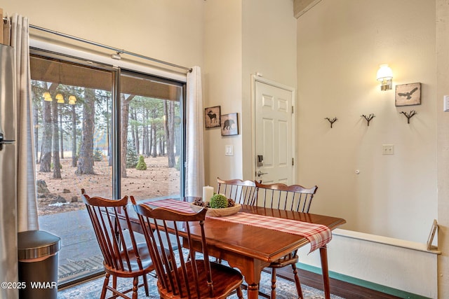 dining area with a towering ceiling