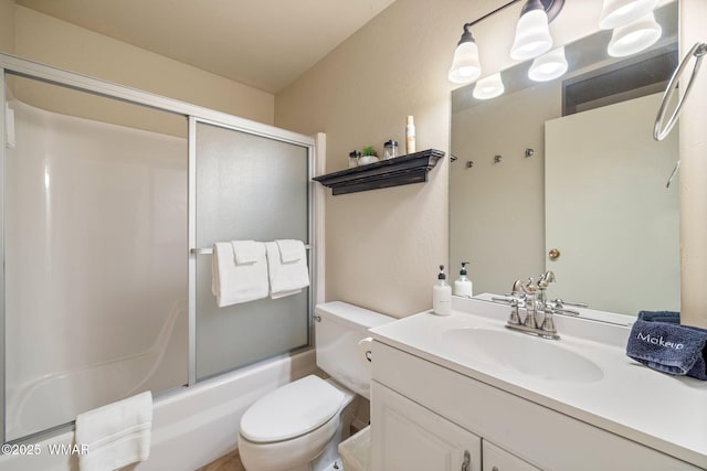 bathroom with toilet, shower / bath combination with glass door, and vanity