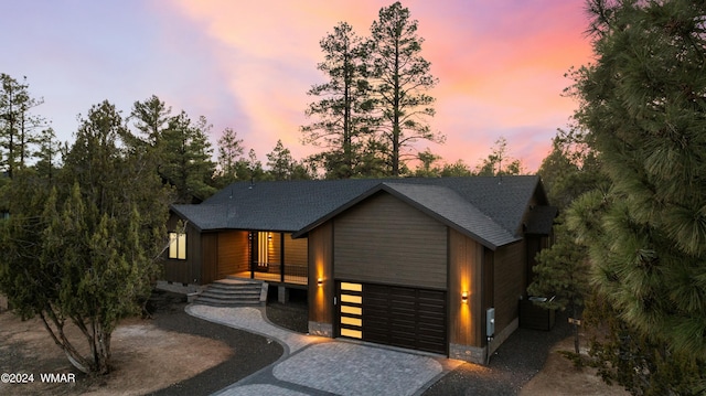 contemporary house featuring decorative driveway and a garage