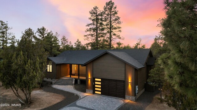 contemporary house with a garage and decorative driveway