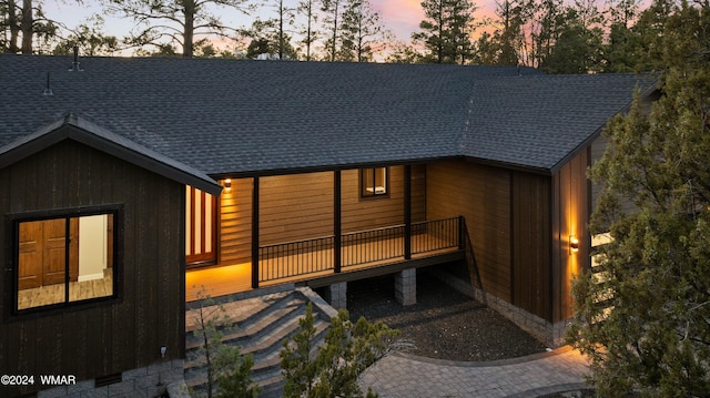 2780 N Eagle View Cir, Show Low, AZ 85901 - back of house at dusk featuring a shingled roof and a deck