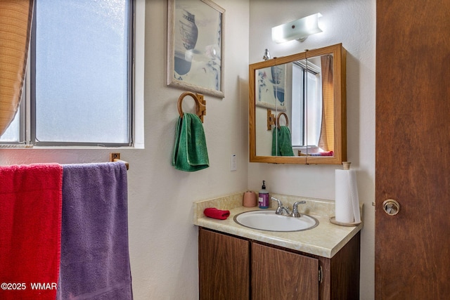 bathroom featuring vanity and a textured wall