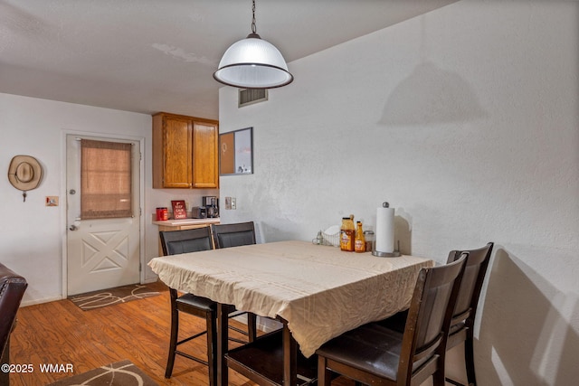 dining space with visible vents and dark wood finished floors