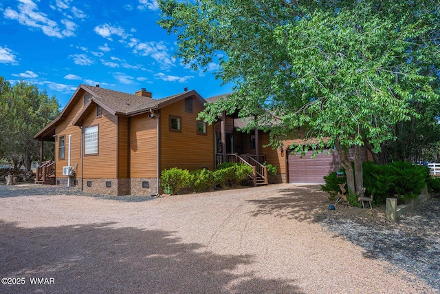 6757 Cheney Ranch Loop, Show Low, AZ 85901 - view of front facade with driveway, an attached garage, and a chimney