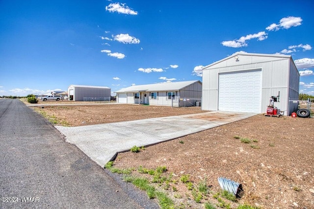 exterior space featuring concrete driveway and an outdoor structure