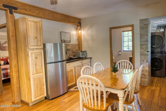 2020 S Pleasantview Dr, Show Low, AZ 85901 - dining space featuring stacked washer / drying machine, light wood-style floors, and beam ceiling