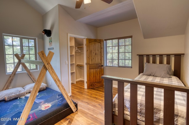 2020 S Pleasantview Dr, Show Low, AZ 85901 - bedroom featuring light wood finished floors, multiple windows, a spacious closet, lofted ceiling, and a ceiling fan