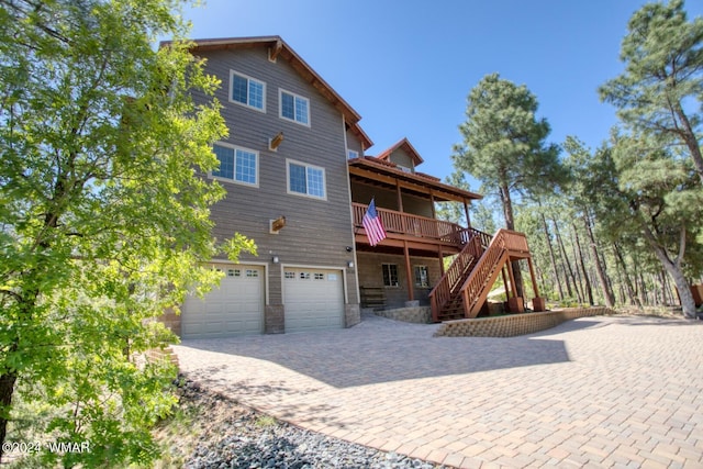 2020 S Pleasantview Dr, Show Low, AZ 85901 - back of property featuring a garage, stairs, a deck, and driveway