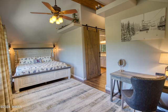 2020 S Pleasantview Dr, Show Low, AZ 85901 - bedroom with vaulted ceiling, a barn door, wood finished floors, baseboards, and ensuite bath