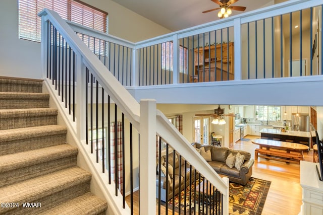 2020 S Pleasantview Dr, Show Low, AZ 85901 - stairs featuring a ceiling fan, a high ceiling, and wood finished floors