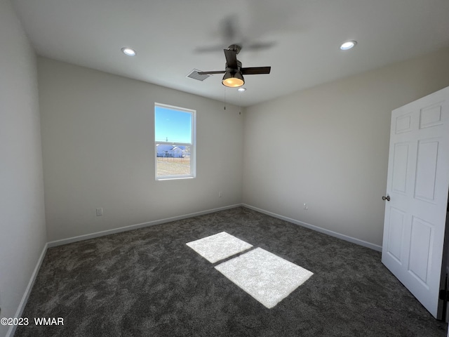 unfurnished room with baseboards, visible vents, dark colored carpet, and recessed lighting