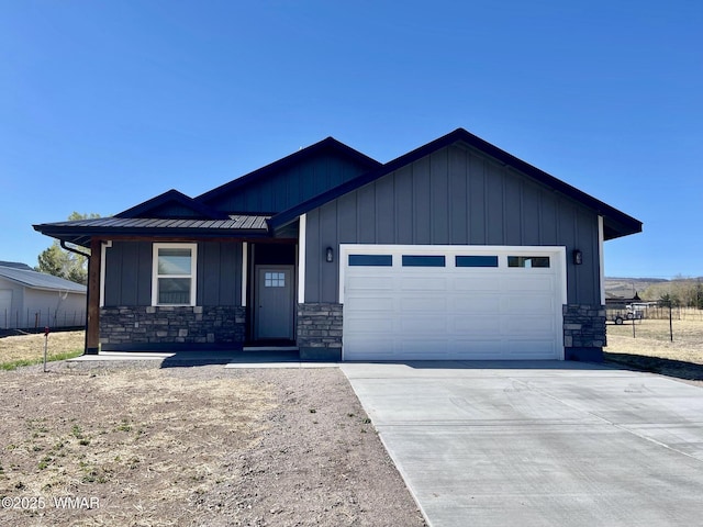 253 E 5th Ave, Eagar, AZ 85925 - view of front of home featuring stone siding, an attached garage, driveway, and board and batten siding