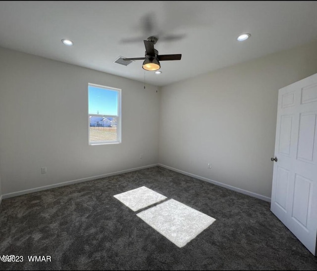 empty room with ceiling fan, visible vents, dark colored carpet, and recessed lighting