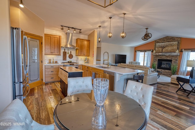 1420 W Haystack Rd, Taylor, AZ 85939 - kitchen with wall chimney range hood, stainless steel appliances, lofted ceiling, dark wood finished floors, and wood counters