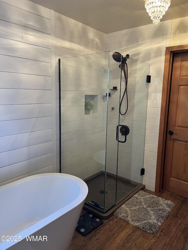 1420 W Haystack Rd, Taylor, AZ 85939 - bathroom featuring wood finished floors, a stall shower, and a freestanding bath