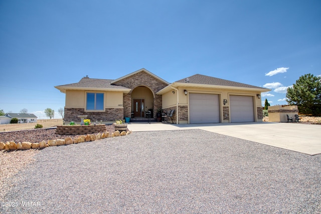 1420 W Haystack Rd, Taylor, AZ 85939 - view of front facade with stucco siding, a garage, driveway, and stone siding