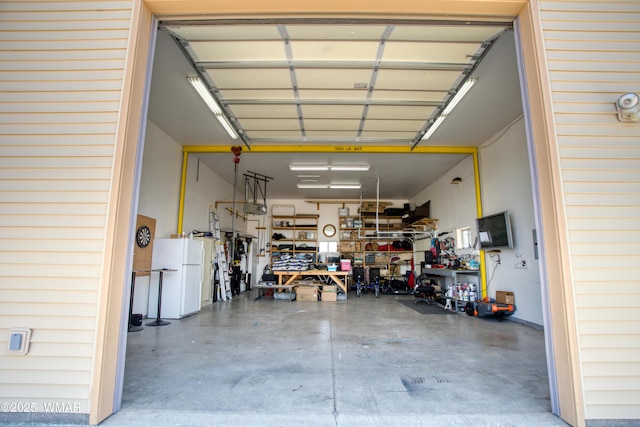 1420 W Haystack Rd, Taylor, AZ 85939 - garage featuring freestanding refrigerator and a workshop area